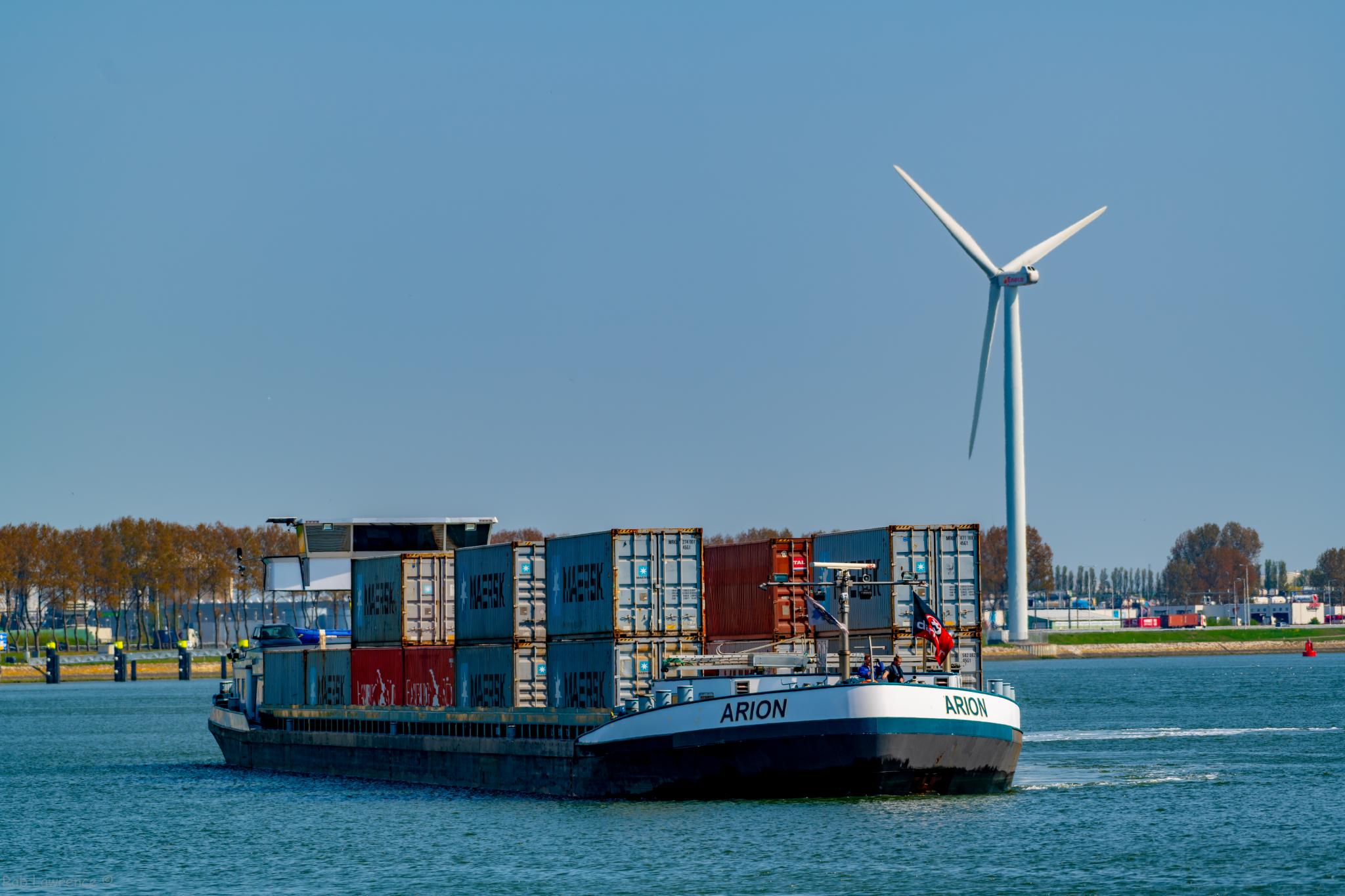 cargo ship with carrying containers on a river