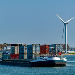 cargo ship with containers on a river